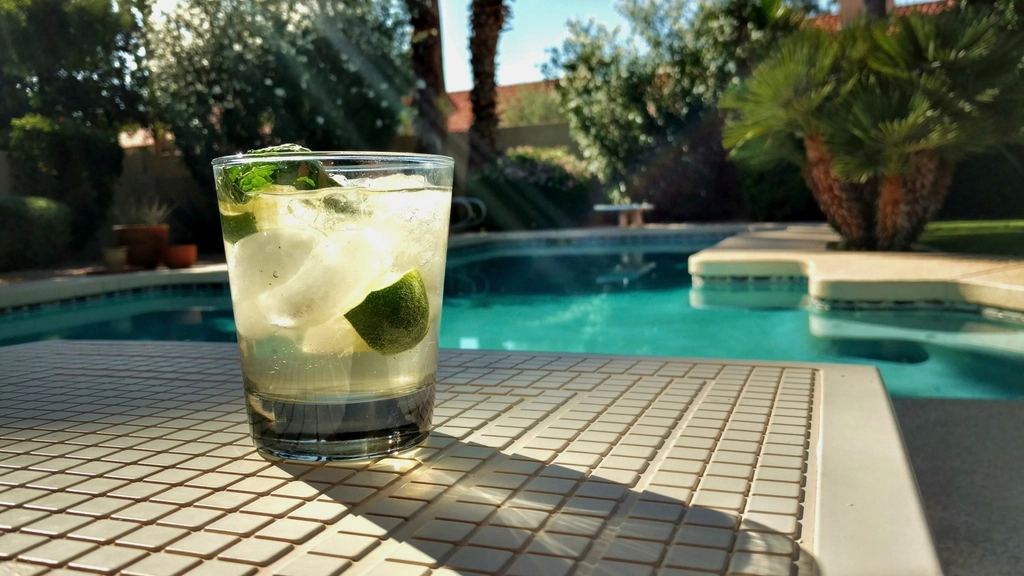 A refreshing cocktail on a sunny poolside table